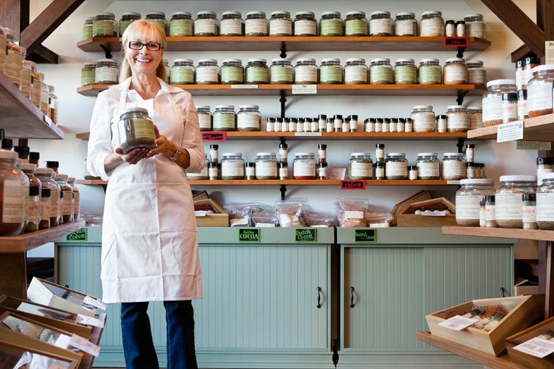 a herb shop owner holder her products
